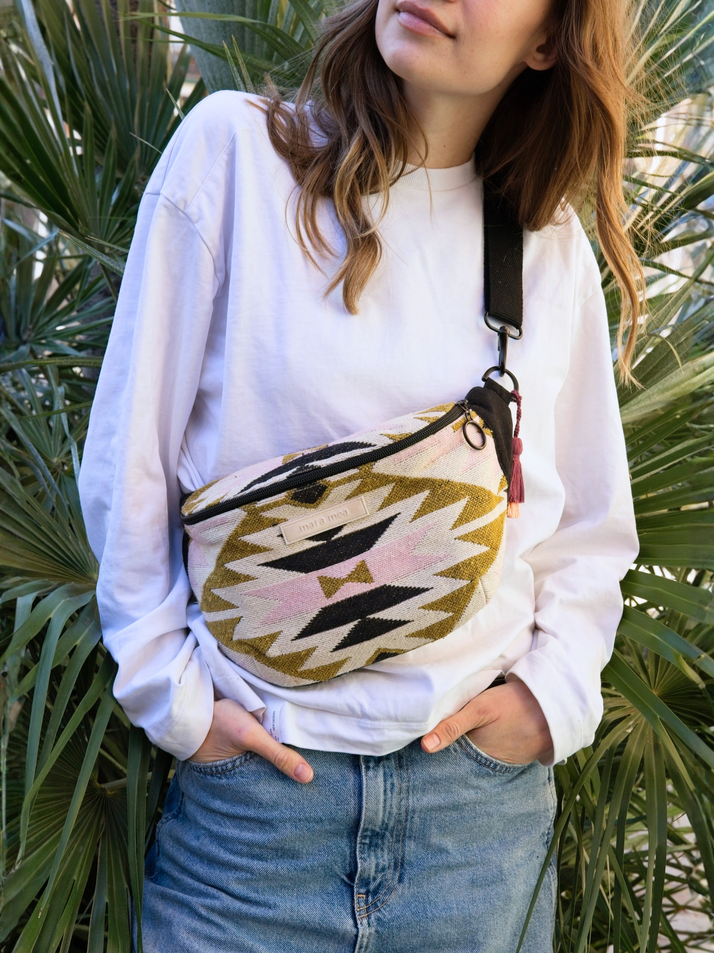 young model with midi bum bag cosmic crush in botanical enviroment.