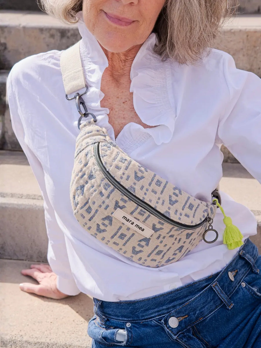 Frau mit der Mini Bauchtasche rough love in Beige-Blaugrau mit Monogramm-Muster