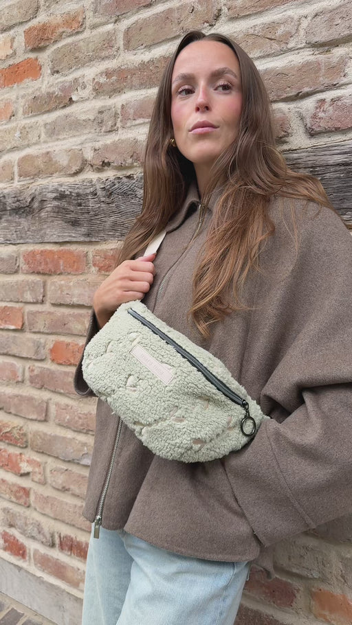 Video, Frau öffnet die Mini Bauchtasche soft rebellion, holt etwas heraus, schließt sie und trägt sie auf dem Rücken