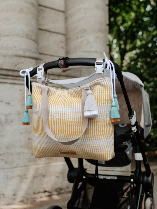 Die unisex Kinderwagentasche buttercup trilogy in beige/gelb ist ein optimales Geschenk zur Geburt